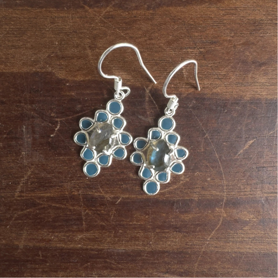 Silver earrings with Labradorite on a wooden surface